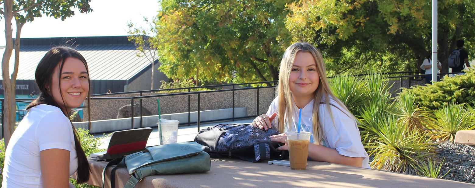 Students at a table on campus